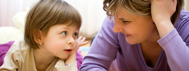 Single mother reading picture book with daughter